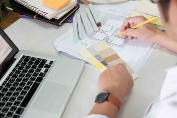 Graphic design and color swatches and pens on a desk. Architectural drawing with work tools and accessories.